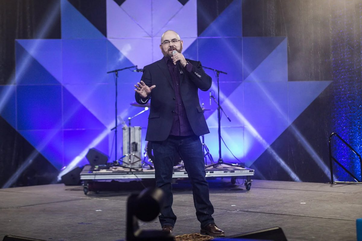 Brandt Krueger speaking on stage